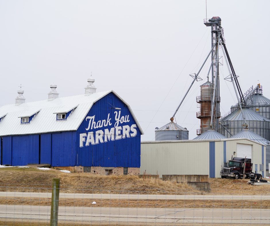 "Thank You Farmers" written on the side of a blue barn